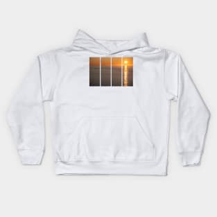 Wonderful landscapes in Norway. Nord-Norge. Beautiful scenery of a midnight sun sunset at Nordkapp (Cape North). Boat and globe on a cliff. Rippled sea and clear orange sky. Kids Hoodie